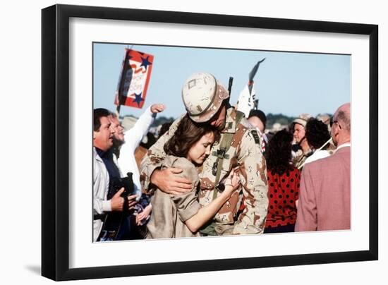Returning US Soldier Hugs Loved One Amid Other Celebrating Families and Friends-null-Framed Photo