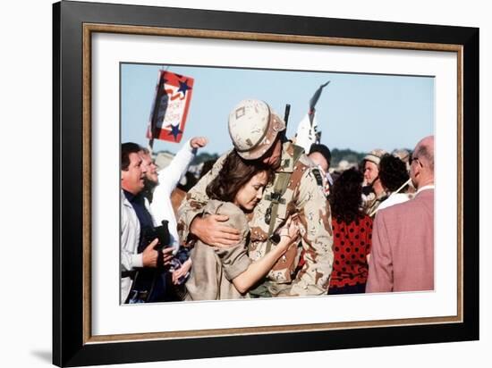 Returning US Soldier Hugs Loved One Amid Other Celebrating Families and Friends-null-Framed Photo