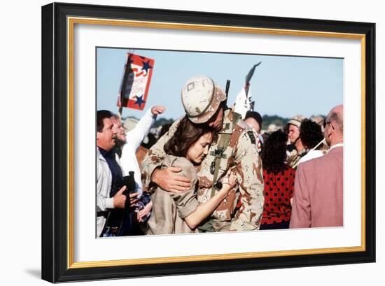 Returning US Soldier Hugs Loved One Amid Other Celebrating Families and Friends-null-Framed Photo