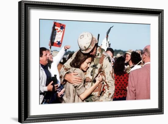 Returning US Soldier Hugs Loved One Amid Other Celebrating Families and Friends-null-Framed Photo