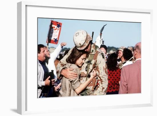 Returning US Soldier Hugs Loved One Amid Other Celebrating Families and Friends-null-Framed Photo