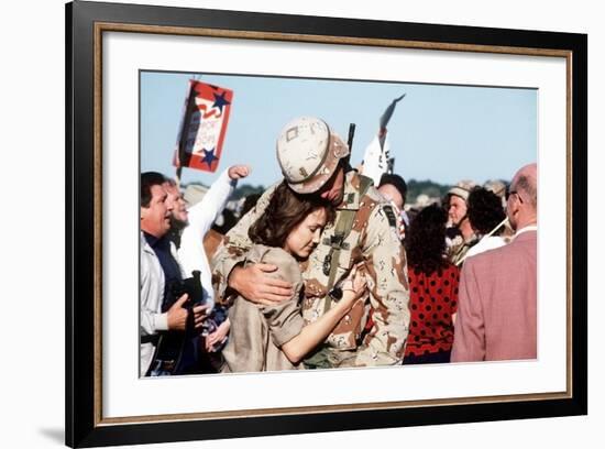 Returning US Soldier Hugs Loved One Amid Other Celebrating Families and Friends-null-Framed Photo