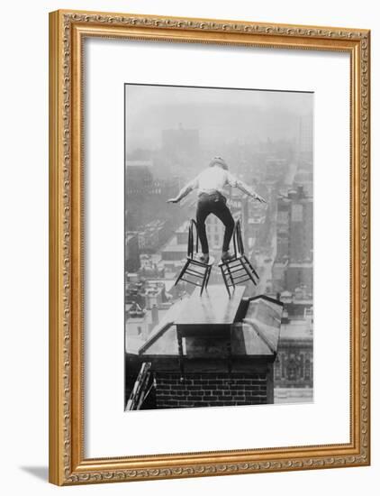 Reynolds Performs a Balancing Act on Roof in New York City-null-Framed Art Print