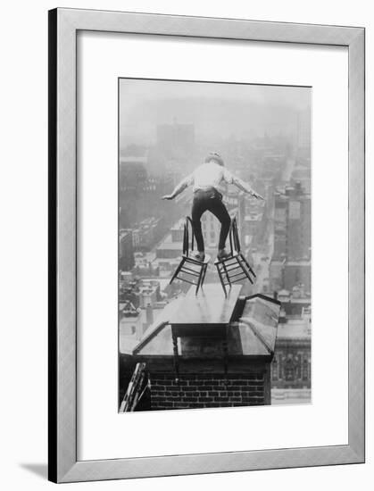 Reynolds Performs a Balancing Act on Roof in New York City-null-Framed Art Print