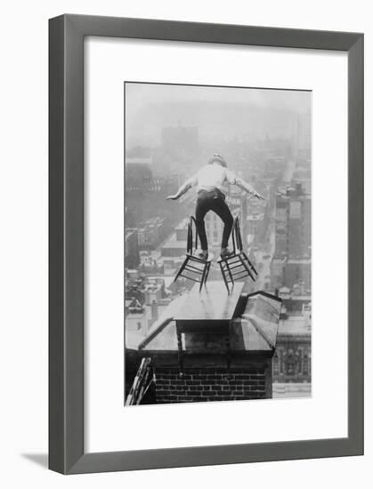 Reynolds Performs a Balancing Act on Roof in New York City-null-Framed Art Print