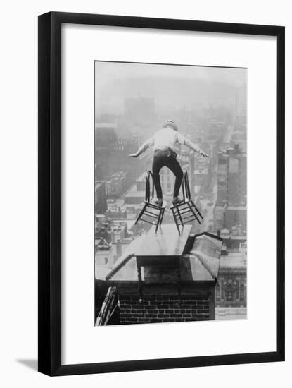 Reynolds Performs a Balancing Act on Roof in New York City-null-Framed Art Print