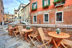Wooden Tables on Narrow Street among Typical Colorful Houses and Small Bridge in Venice, Italy.-rglinsky-Photographic Print