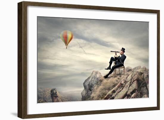 Rich Businessman Sitting On A Chair In The Mountain Looking The Landscape With Spyglass-olly2-Framed Art Print