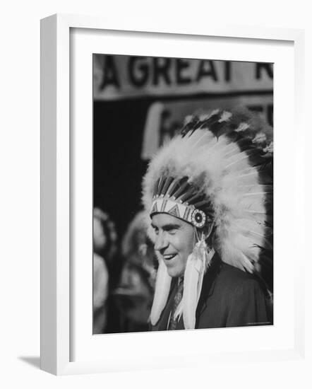 Richard M. Nixon Wearing Plains Indian Bonnet-Paul Schutzer-Framed Photographic Print