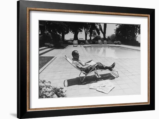 Richard Nixon Reading Newspapers While Sitting by the Pool in San Clemente, Ca. 1969-74-null-Framed Photo