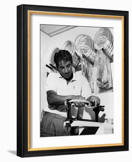 Richard 'Pancho' Gonzales Restringing a Tennis Racket in 1962-null-Framed Photo