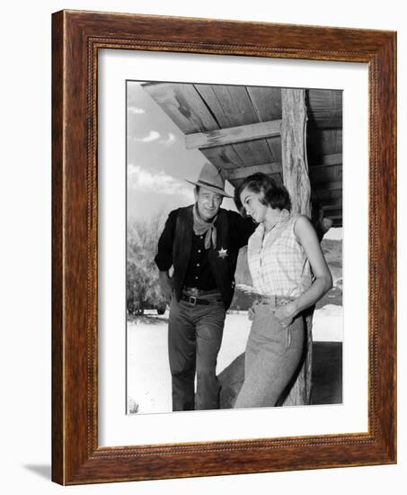 RIO BRAVO, 1959 directed by HOWARD HAWKS On the set, John Wayne and Angie Dickinson (b/w photo)-null-Framed Photo