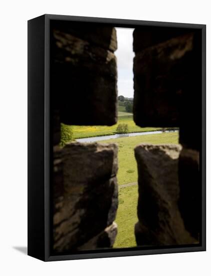 River Aln Seen Through Arrow Slit of Walls of Alnwick Castle, Northumberland, England-Nick Servian-Framed Premier Image Canvas