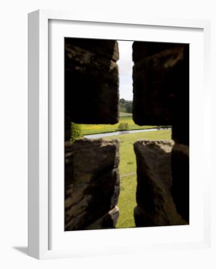 River Aln Seen Through Arrow Slit of Walls of Alnwick Castle, Northumberland, England-Nick Servian-Framed Photographic Print