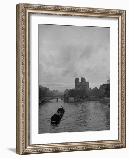 River Barge Churning up the Seine Past Notre Dame Cathedral on a Gloomy Winter Day-Ed Clark-Framed Photographic Print