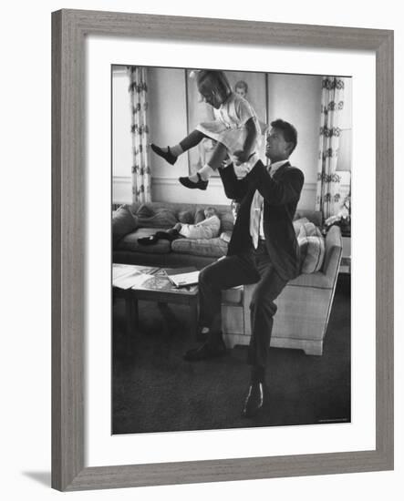 Robert F. Kennedy Playfully Tossing His Daughter Mary Kerry Kennedy Into the Air-John Dominis-Framed Premium Photographic Print