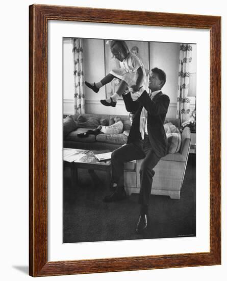 Robert F. Kennedy Playfully Tossing His Daughter Mary Kerry Kennedy Into the Air-John Dominis-Framed Premium Photographic Print