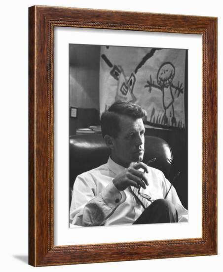 Robert F. Kennedy Sitting in Office in Front of Child's Painting-null-Framed Photographic Print