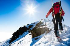 Mountaineer Walking up along a Snowy Ridge with the Skis in the Backpack. in Background a Shiny Bri-Roberto Caucino-Framed Premier Image Canvas