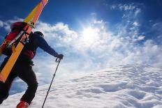 Mountaineer Walking up along a Snowy Ridge with the Skis in the Backpack. in Background a Shiny Bri-Roberto Caucino-Framed Premier Image Canvas