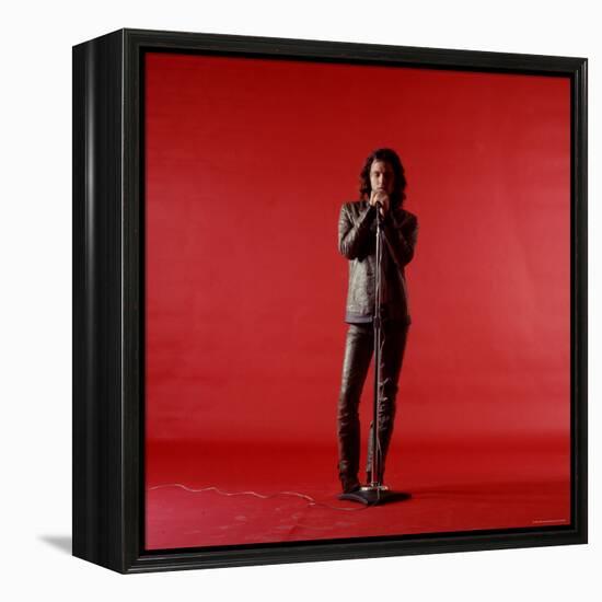 Rock Star Jim Morrison of the Doors Holding Microphone Alone as He Stands Against a Red Backdrop-Yale Joel-Framed Premier Image Canvas