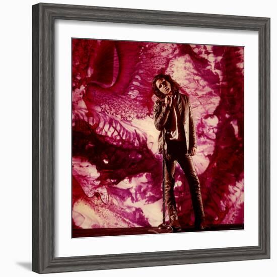 Rock Star Jim Morrison of the Doors Standing Alone in Front of a Purple Psychedelic Backdrop-Yale Joel-Framed Premium Photographic Print