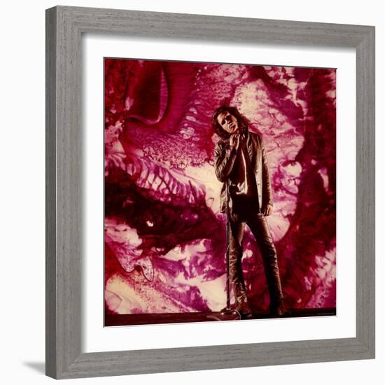 Rock Star Jim Morrison of the Doors Standing Alone in Front of a Purple Psychedelic Backdrop-Yale Joel-Framed Premium Photographic Print