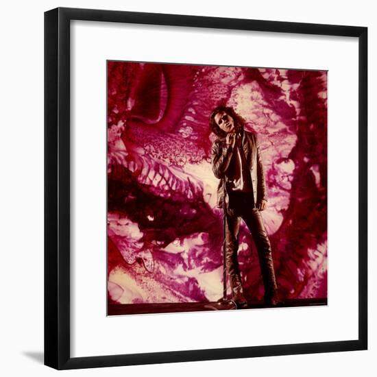 Rock Star Jim Morrison of the Doors Standing Alone in Front of a Purple Psychedelic Backdrop-Yale Joel-Framed Premium Photographic Print