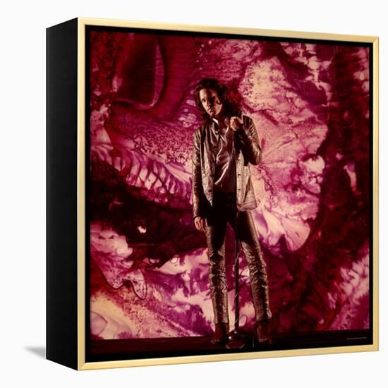 Rock Star Jim Morrison of the Doors Standing Alone in Front of a Purple Psychedelic Background-Yale Joel-Framed Premier Image Canvas