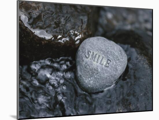 Rock with the Word Smile in Rushing Water-null-Mounted Photographic Print