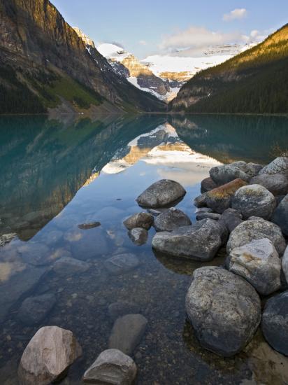 Rocky Mountains And Boulders Reflected In Lake Louise Banff National