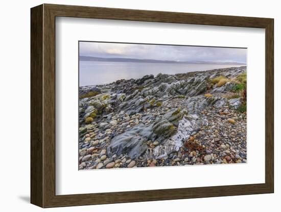 Rocky shore near Pirnmill looking out across the Kilbrannan Sound to Mull of Kintyre, Isle of Arran-Gary Cook-Framed Photographic Print