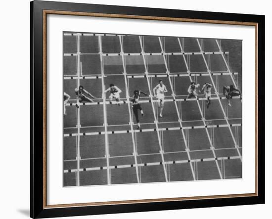 Rod Milburn Leading in the 110 Meter Hurdles at Summer Olympics-John Dominis-Framed Premium Photographic Print