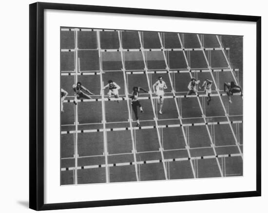 Rod Milburn Leading in the 110 Meter Hurdles at Summer Olympics-John Dominis-Framed Premium Photographic Print