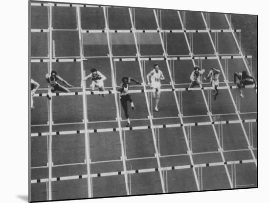 Rod Milburn Leading in the 110 Meter Hurdles at Summer Olympics-John Dominis-Mounted Premium Photographic Print