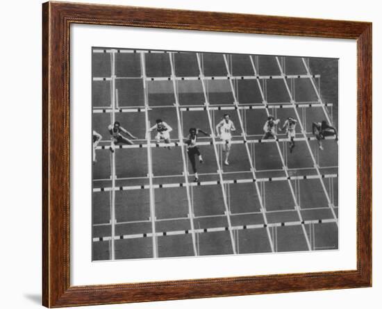 Rod Milburn Leading in the 110 Meter Hurdles at Summer Olympics-John Dominis-Framed Premium Photographic Print