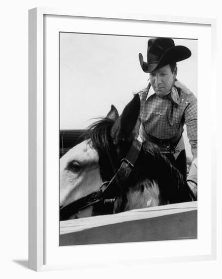 Rodeo Star Casey Tibbs Sitting in the Pen at a Rodeo Just Before His Horse Threw Him-Nat Farbman-Framed Premium Photographic Print