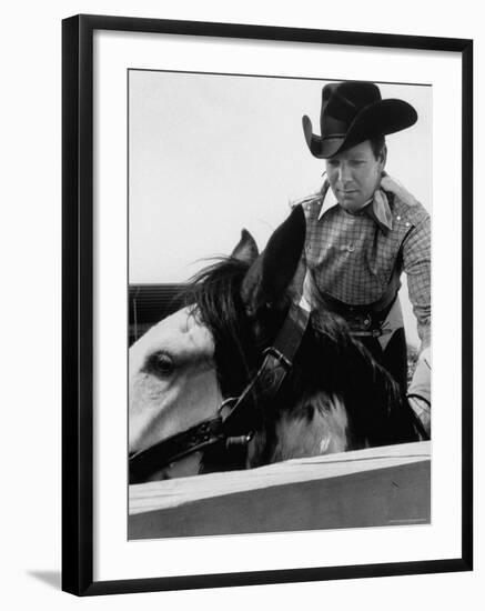 Rodeo Star Casey Tibbs Sitting in the Pen at a Rodeo Just Before His Horse Threw Him-Nat Farbman-Framed Premium Photographic Print