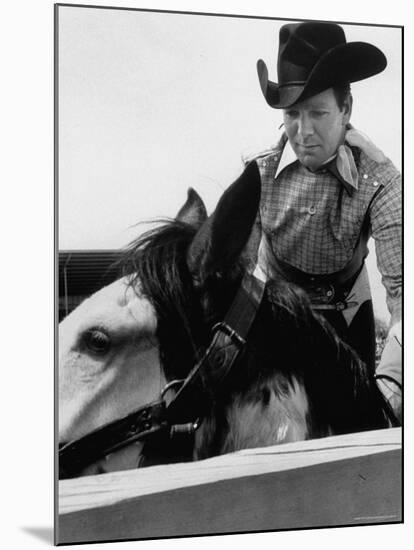 Rodeo Star Casey Tibbs Sitting in the Pen at a Rodeo Just Before His Horse Threw Him-Nat Farbman-Mounted Premium Photographic Print