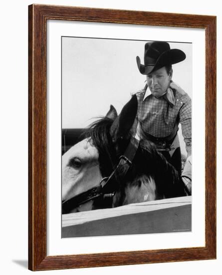 Rodeo Star Casey Tibbs Sitting in the Pen at a Rodeo Just Before His Horse Threw Him-Nat Farbman-Framed Premium Photographic Print