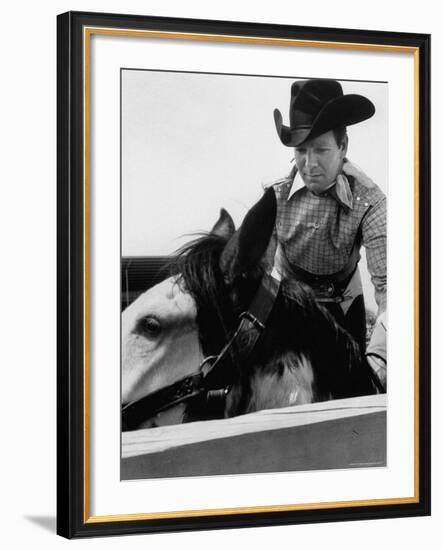 Rodeo Star Casey Tibbs Sitting in the Pen at a Rodeo Just Before His Horse Threw Him-Nat Farbman-Framed Premium Photographic Print