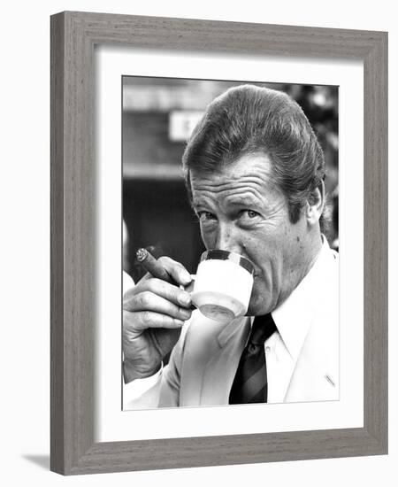 Roger Moore Drinking Coffee-Associated Newspapers-Framed Photo