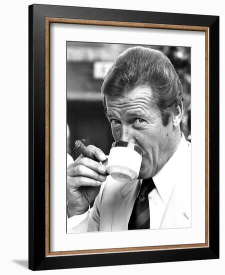 Roger Moore Drinking Coffee-Associated Newspapers-Framed Photo