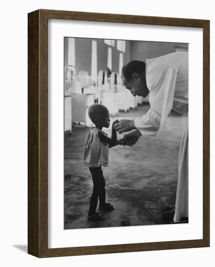 Roman Catholic Priest Chatting with Healing Child-Terence Spencer-Framed Photographic Print