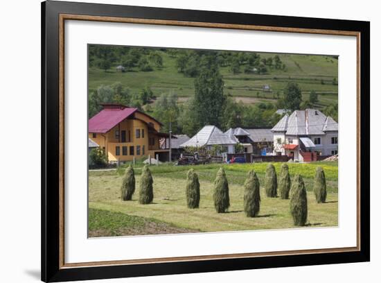 Romania, Maramures Region, Rona de Jos, Village View with Haystacks-Walter Bibikow-Framed Photographic Print