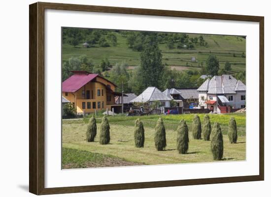 Romania, Maramures Region, Rona de Jos, Village View with Haystacks-Walter Bibikow-Framed Photographic Print