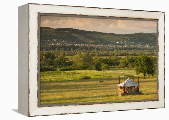 Romania, Maramures Region, Sarasau, Haystack by the Ukrainian Frontier-Walter Bibikow-Framed Premier Image Canvas