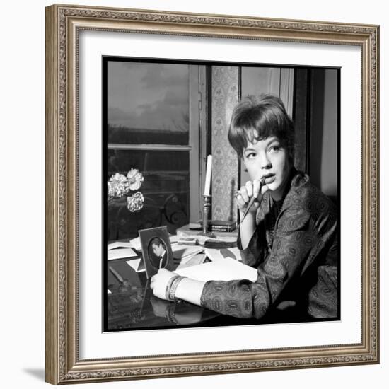 Romy Schneider, Thougthful, Trying to Write a Letter in Front of Alain Delon's Picture-Marcel Begoin-Framed Photographic Print