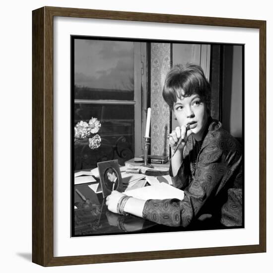 Romy Schneider, Thougthful, Trying to Write a Letter in Front of Alain Delon's Picture-Marcel Begoin-Framed Photographic Print