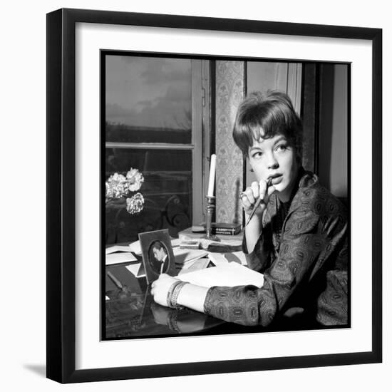 Romy Schneider, Thougthful, Trying to Write a Letter in Front of Alain Delon's Picture-Marcel Begoin-Framed Photographic Print